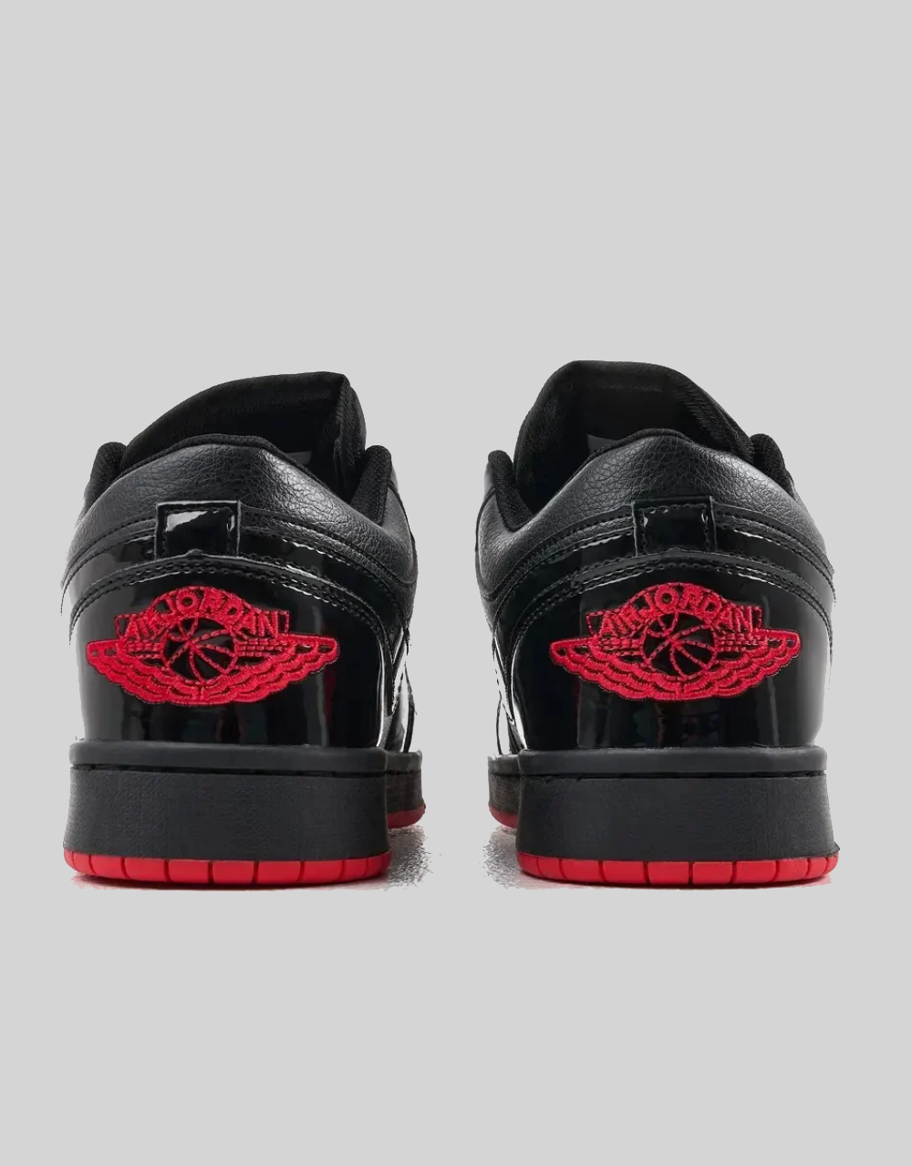 Rear view of Air Jordan 1 Low SP Gina pair showing red embroidered Air Jordan Wings logo on black patent leather heel