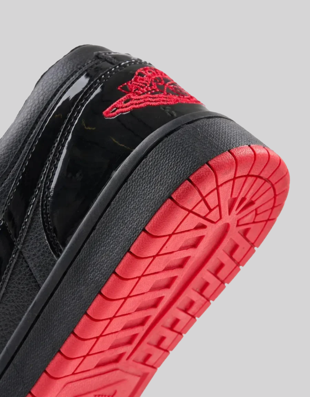 Air Jordan 1 Low SP Gina heel detail showing red embroidered Wings logo and red rubber outsole