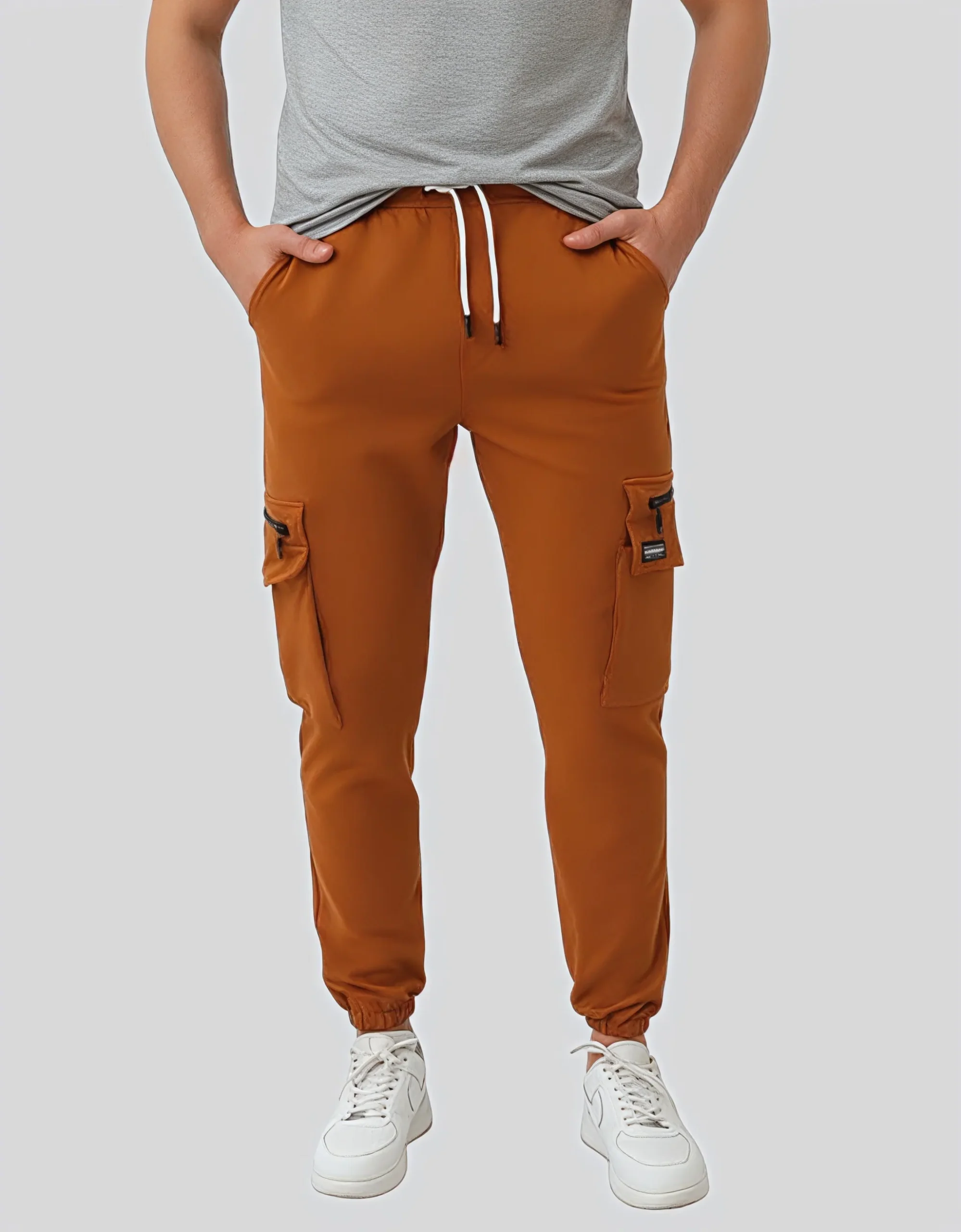 Men's camel cargo jogger pants worn on model front view showing dual cargo pockets and white drawstring waistband