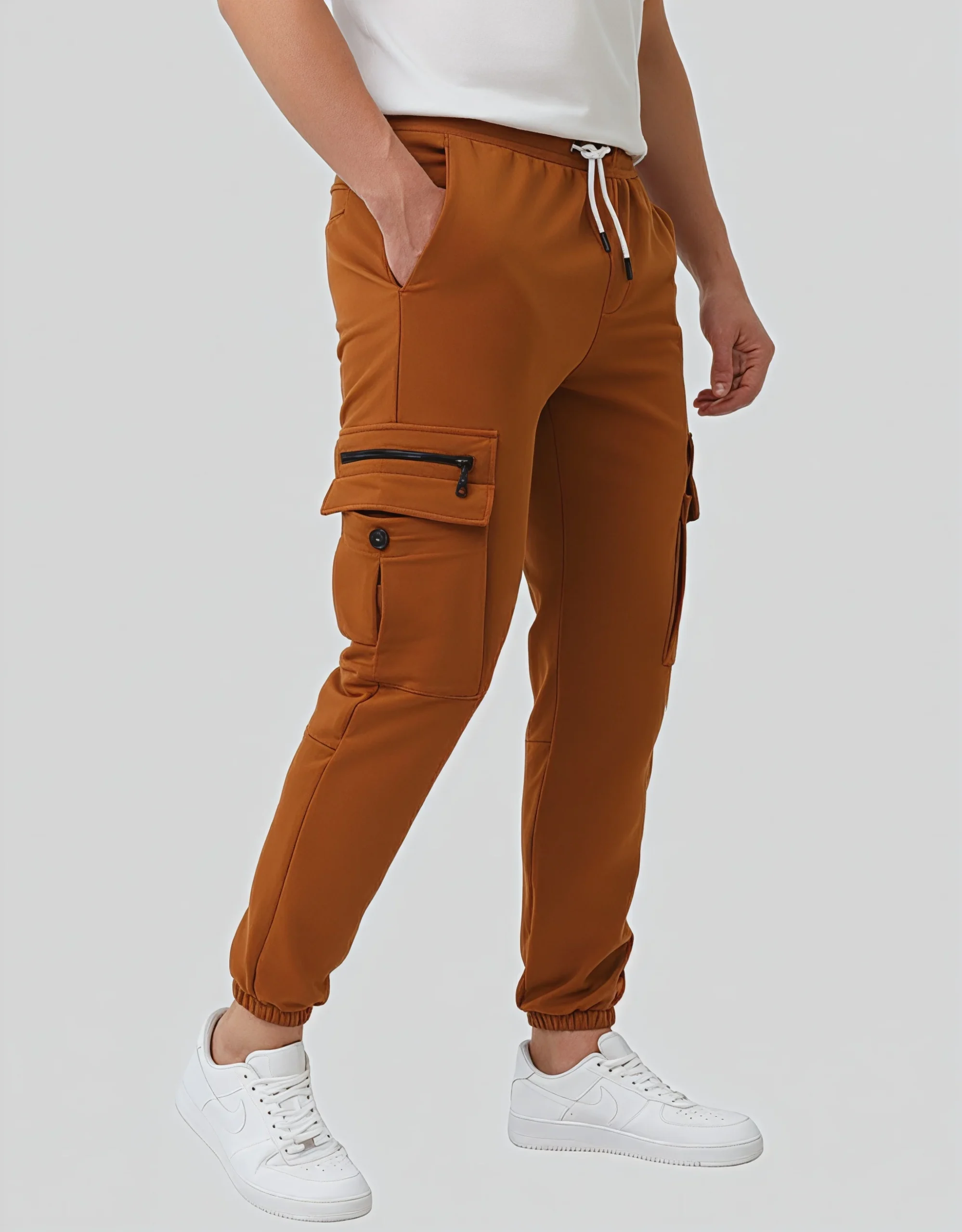 Men's camel cargo jogger pants worn on model right side view showing zippered thigh pocket detail and tapered ankle cuff