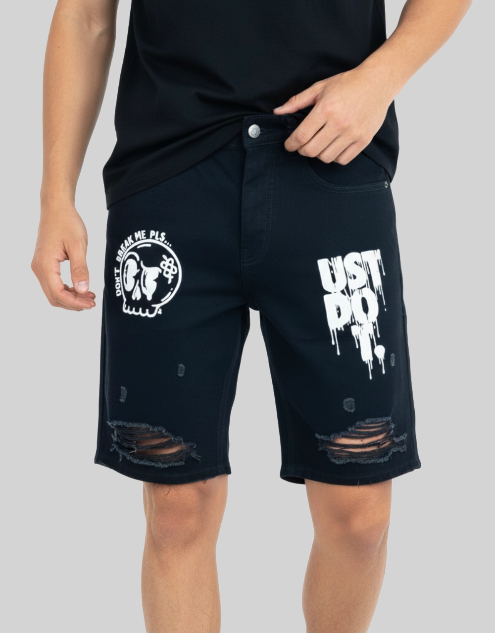 Men's dark blue graphic distressed denim shorts worn on model front view