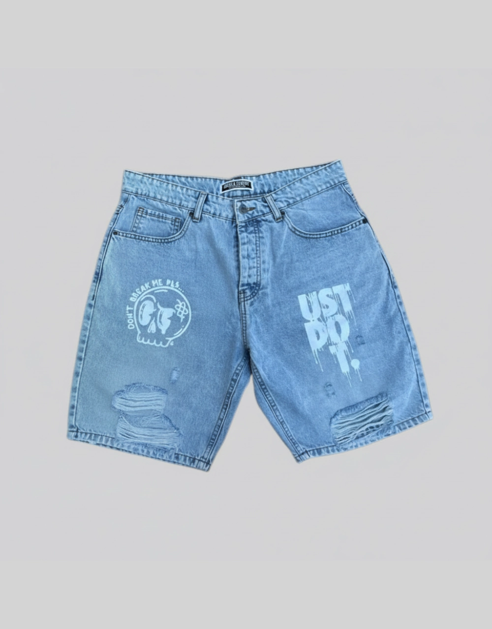 Flat lay of men's light blue distressed denim shorts with graphic screen print