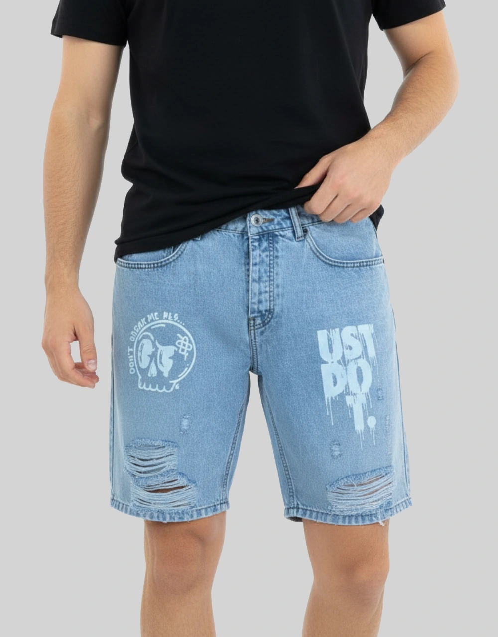 Men's light blue graphic distressed denim shorts worn on model front view
