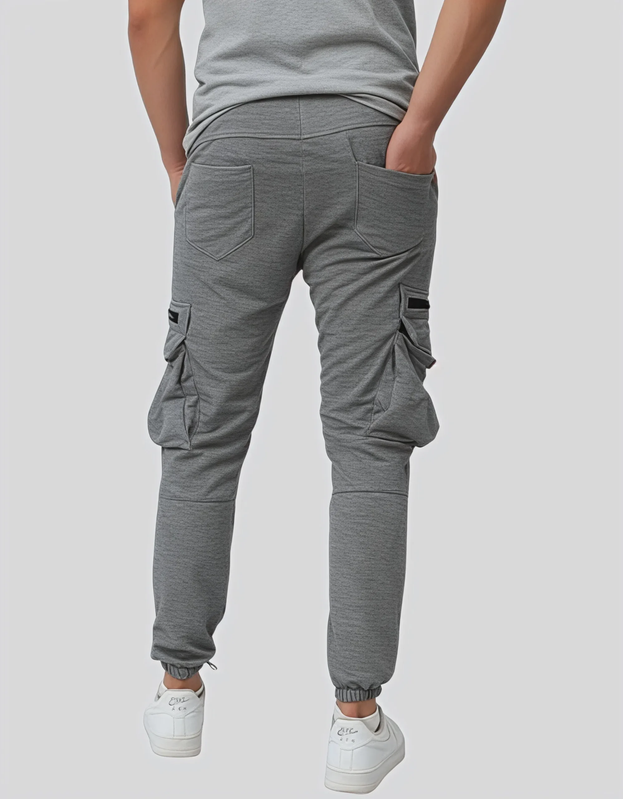 Men's gray cargo jogger pants worn on model back view showing two rear patch pockets and dual thigh cargo pockets