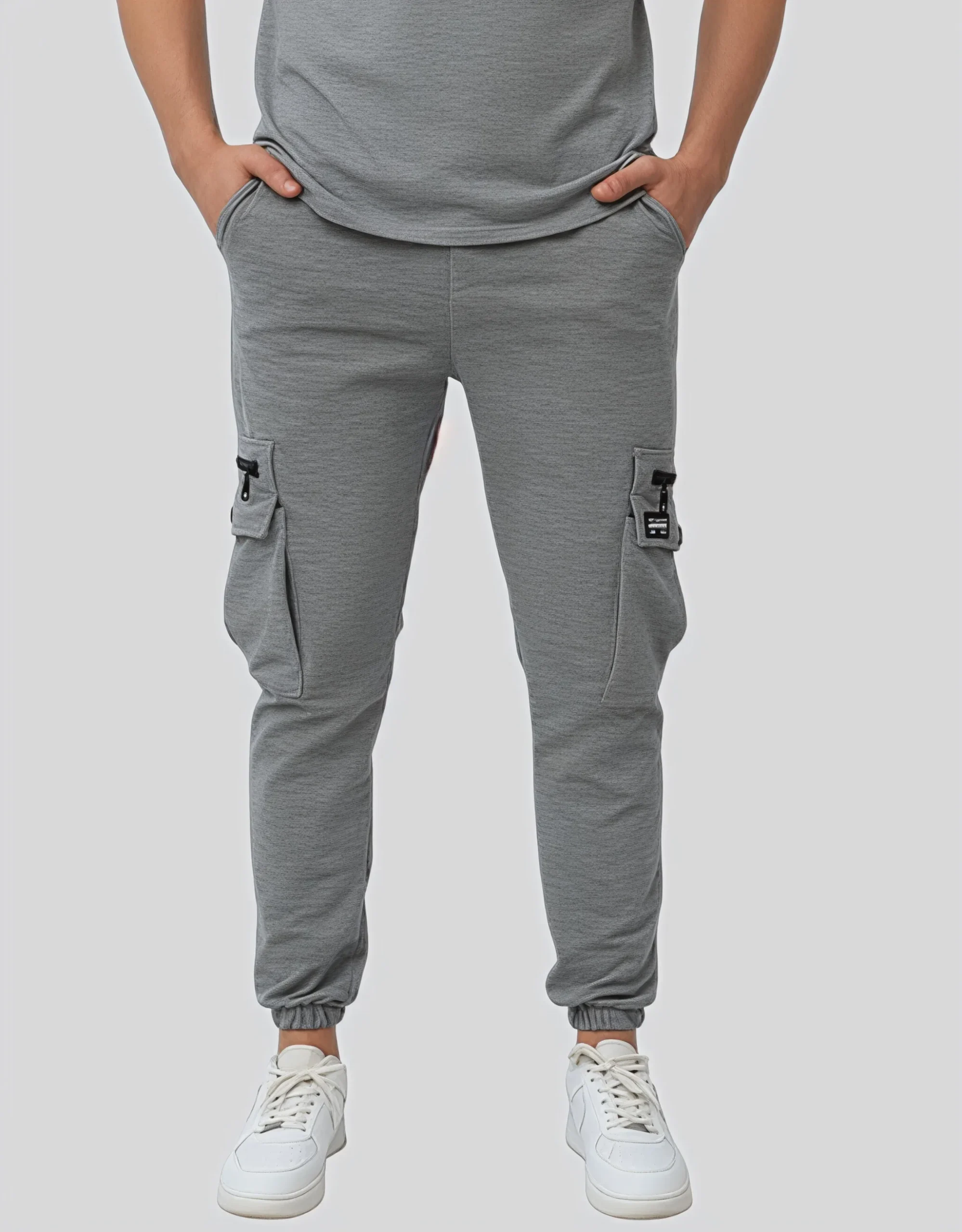 Men's heather gray cargo jogger pants worn on model front view showing dual zippered cargo pockets and elasticated waistband