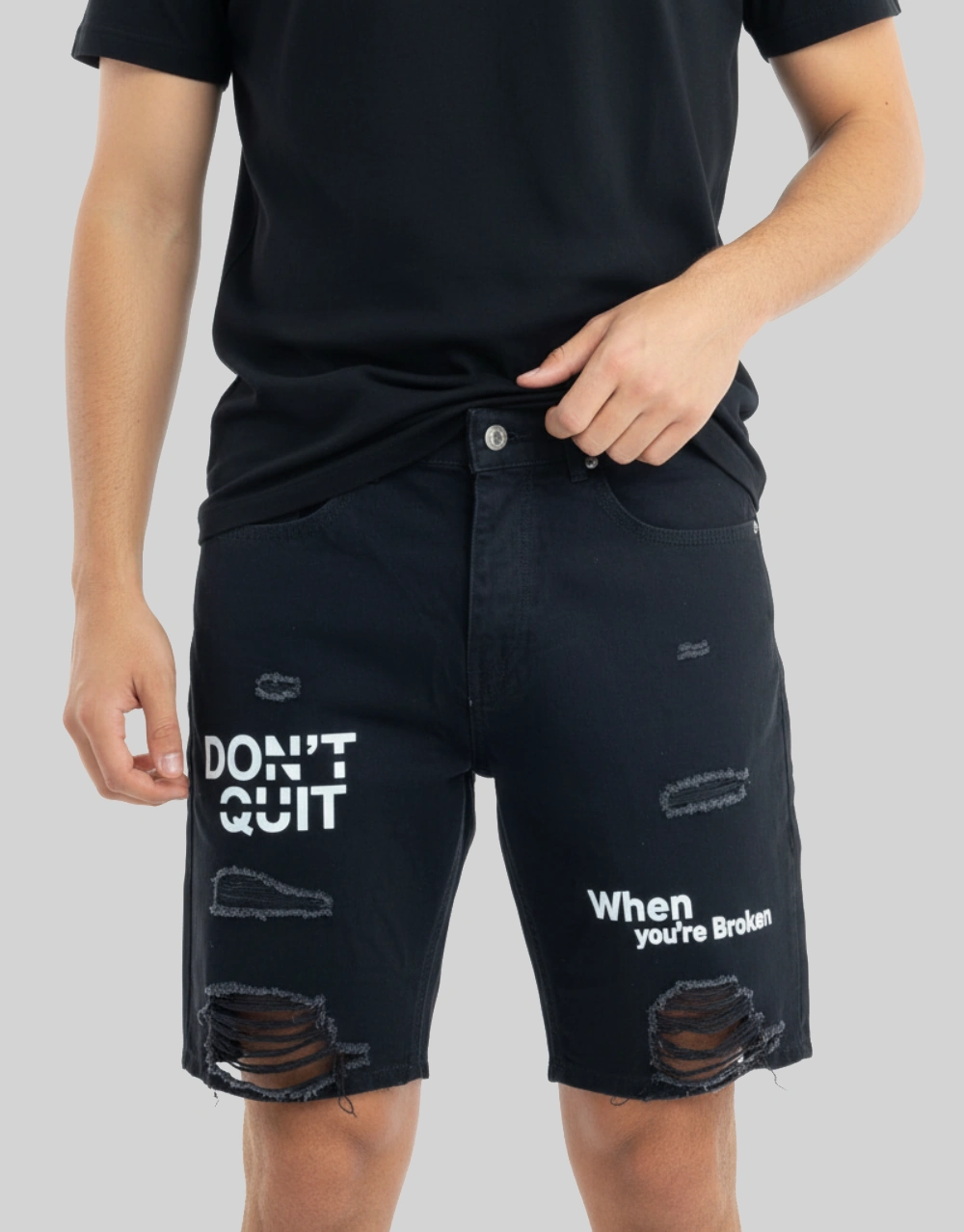 Men's dark blue slogan distressed denim shorts worn on model front view