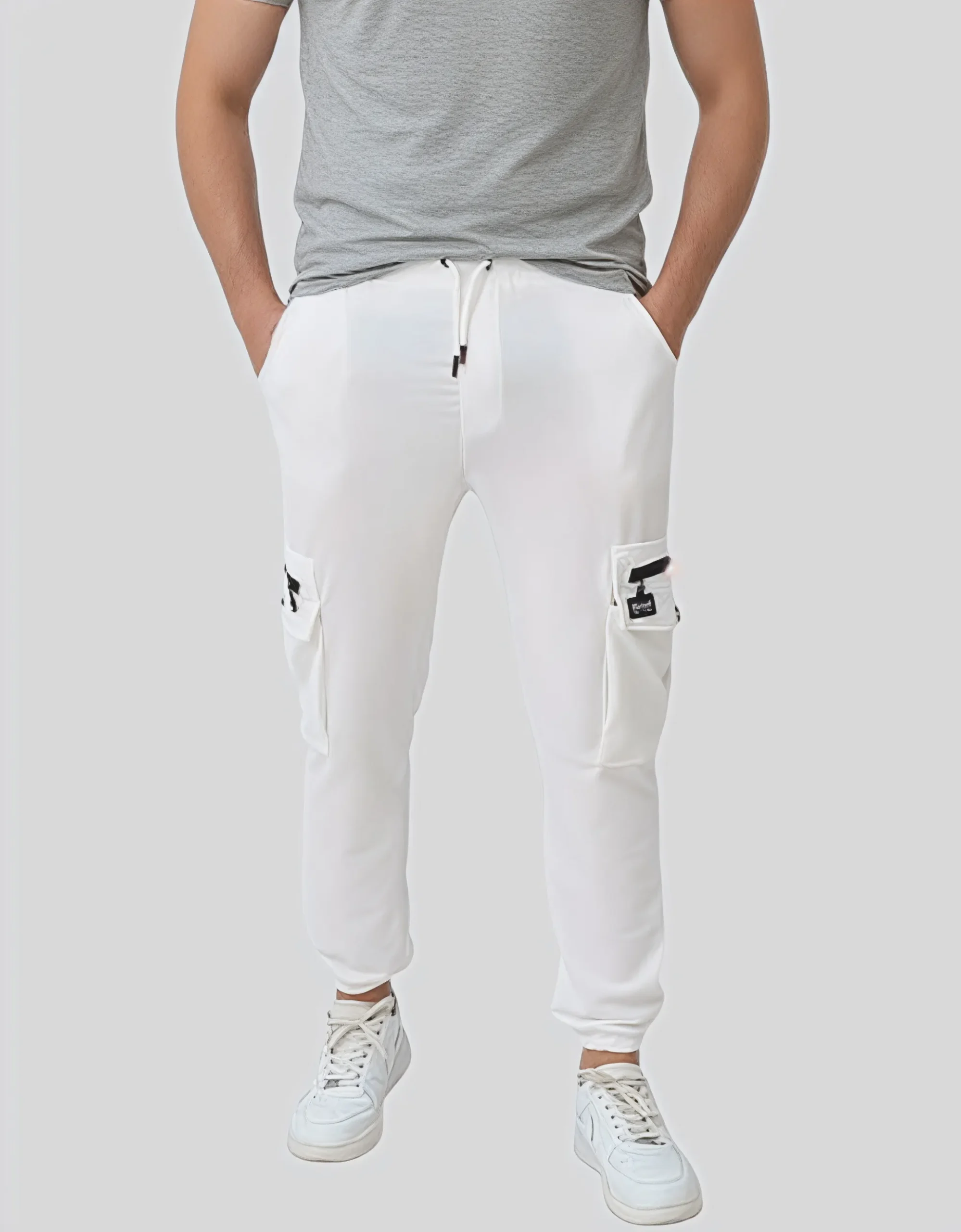 Men's white cargo jogger pants worn on model front view showing dual cargo pockets and drawstring waistband