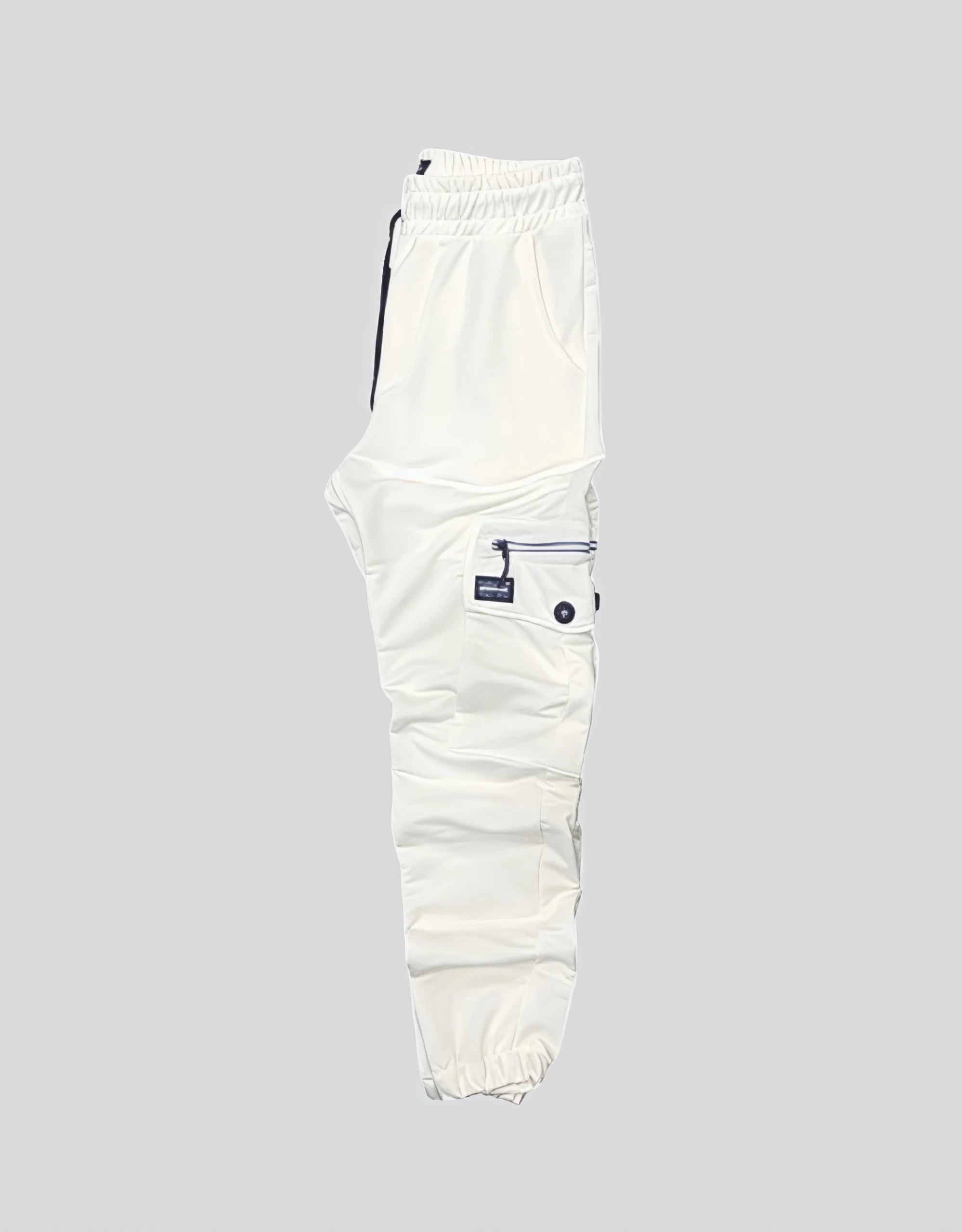 Men's white cargo jogger pants worn on model side view showing zippered thigh pocket and tapered ankle cuff