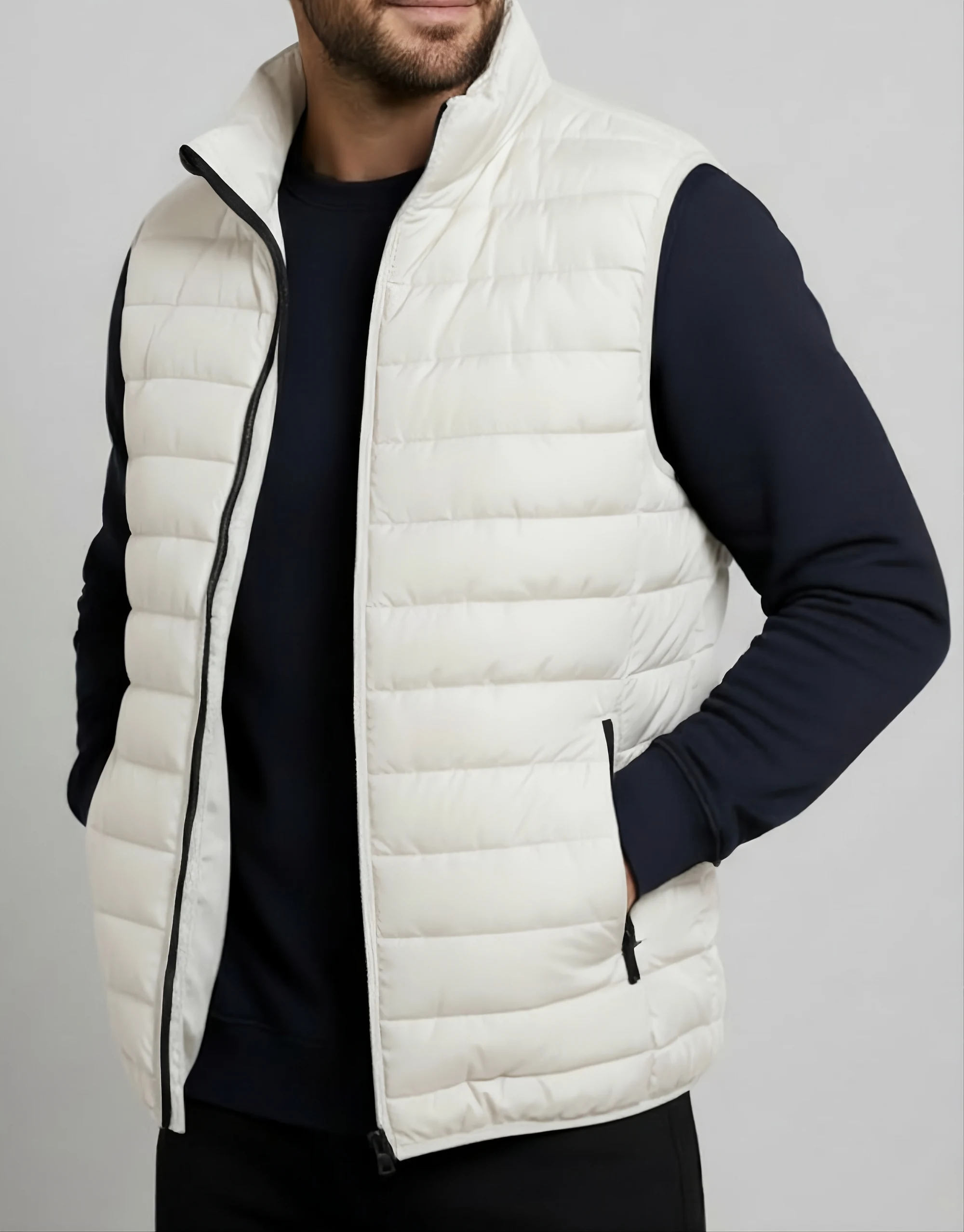 Men's off-white quilted puffer vest worn open on model showing horizontal baffle channels black contrast zipper and zippered side pocket