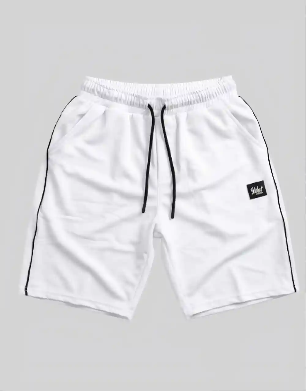 Flat lay of men's white cotton shorts with black contrast side piping and branded patch